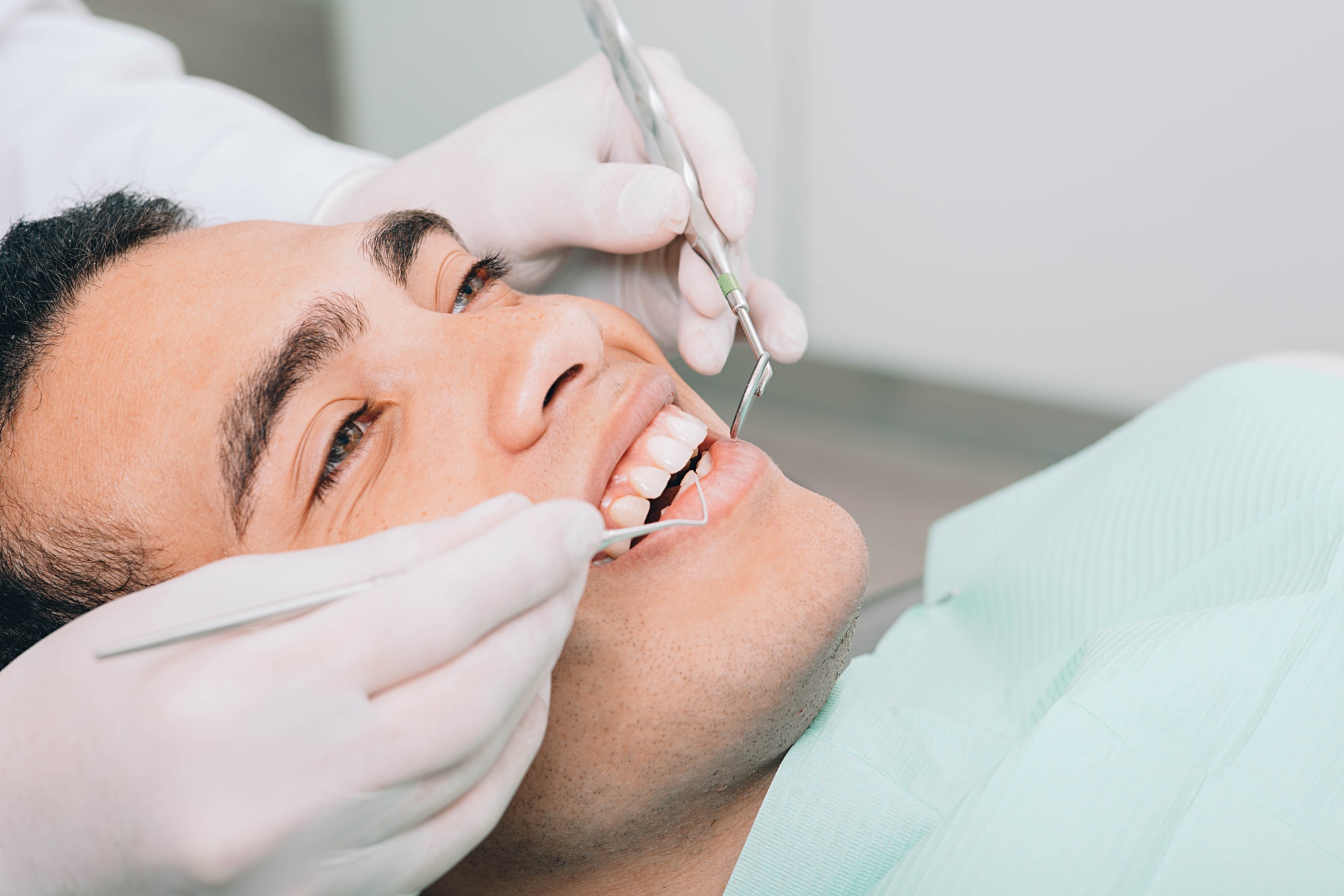 African american man check up teeth with dental equipment