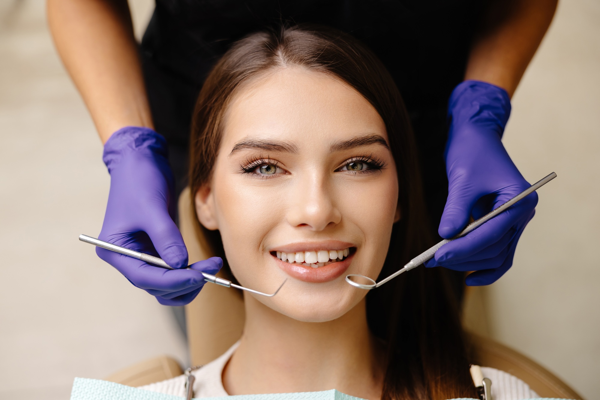 octor is checking teeth using a dental instrument, ensuring proper oral care in the clinic